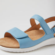Blue sandal with a white sole on a light gray background
