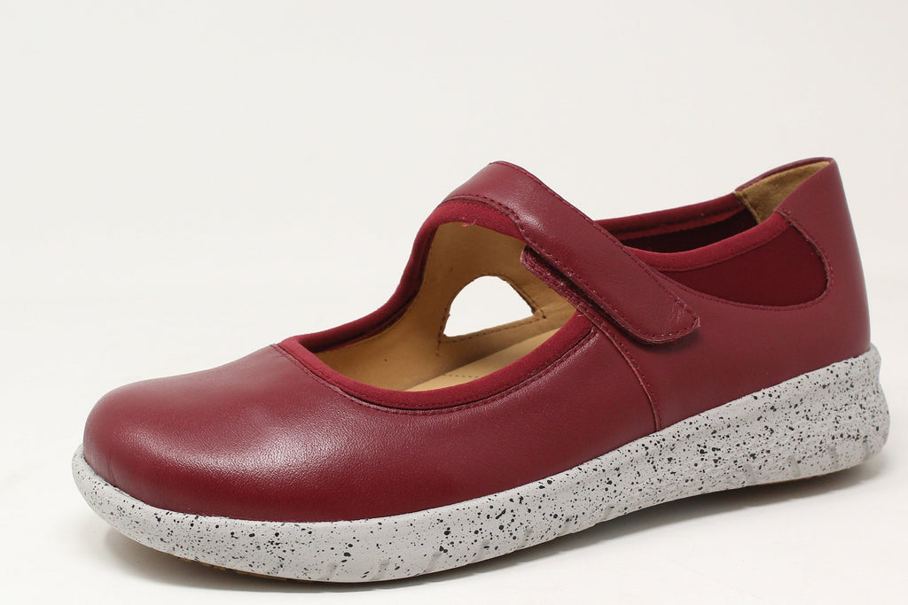 Red shoe with a speckled gray sole on a white background