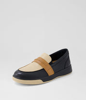 Loafer shoe with black, beige, and brown color scheme on a light gray background