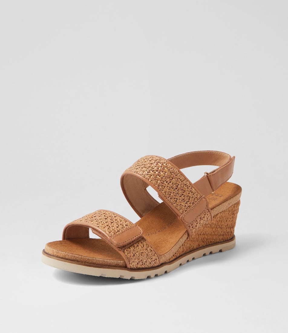 Ziera Kift wedge sandal in coffee-toned raffia with adjustable straps, cushioned footbed, and mid-height wedge sole on a white background