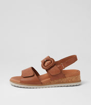 Ziera Vatch wedge sandal in tan leather with adjustable straps, cushioned footbed, and mid-height wedge sole on a white background