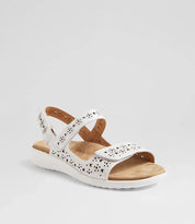 White sandal with brown sole on a light gray background