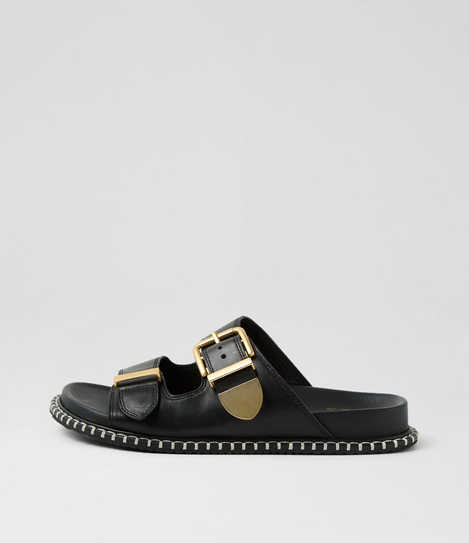 Ziera Iyami sandal in black leather with adjustable straps, brass accents, and supportive low-profile sole on a white background