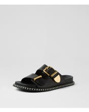 Ziera Iyami sandal in black leather with adjustable straps, brass accents, and supportive low-profile sole on a white background
