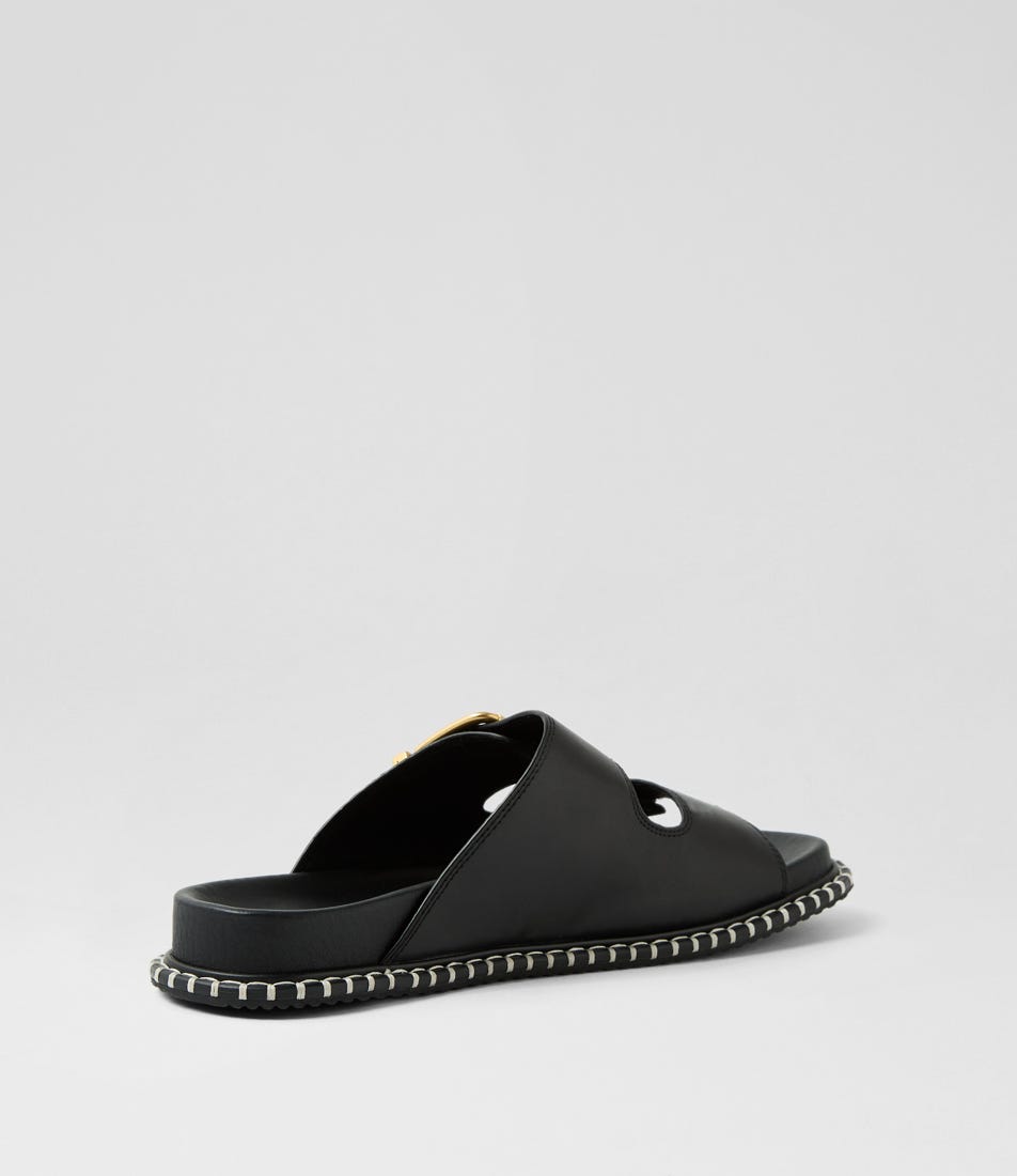 Ziera Iyami sandal in black leather with adjustable straps, brass accents, and supportive low-profile sole on a white background