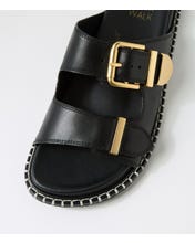 Ziera Iyami sandal in black leather with adjustable straps, brass accents, and supportive low-profile sole on a white background