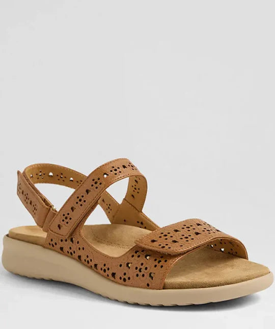 Brown sandal with cut-out design on a light gray background
