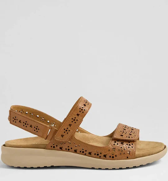 Tan sandal with cut-out design on a light gray background